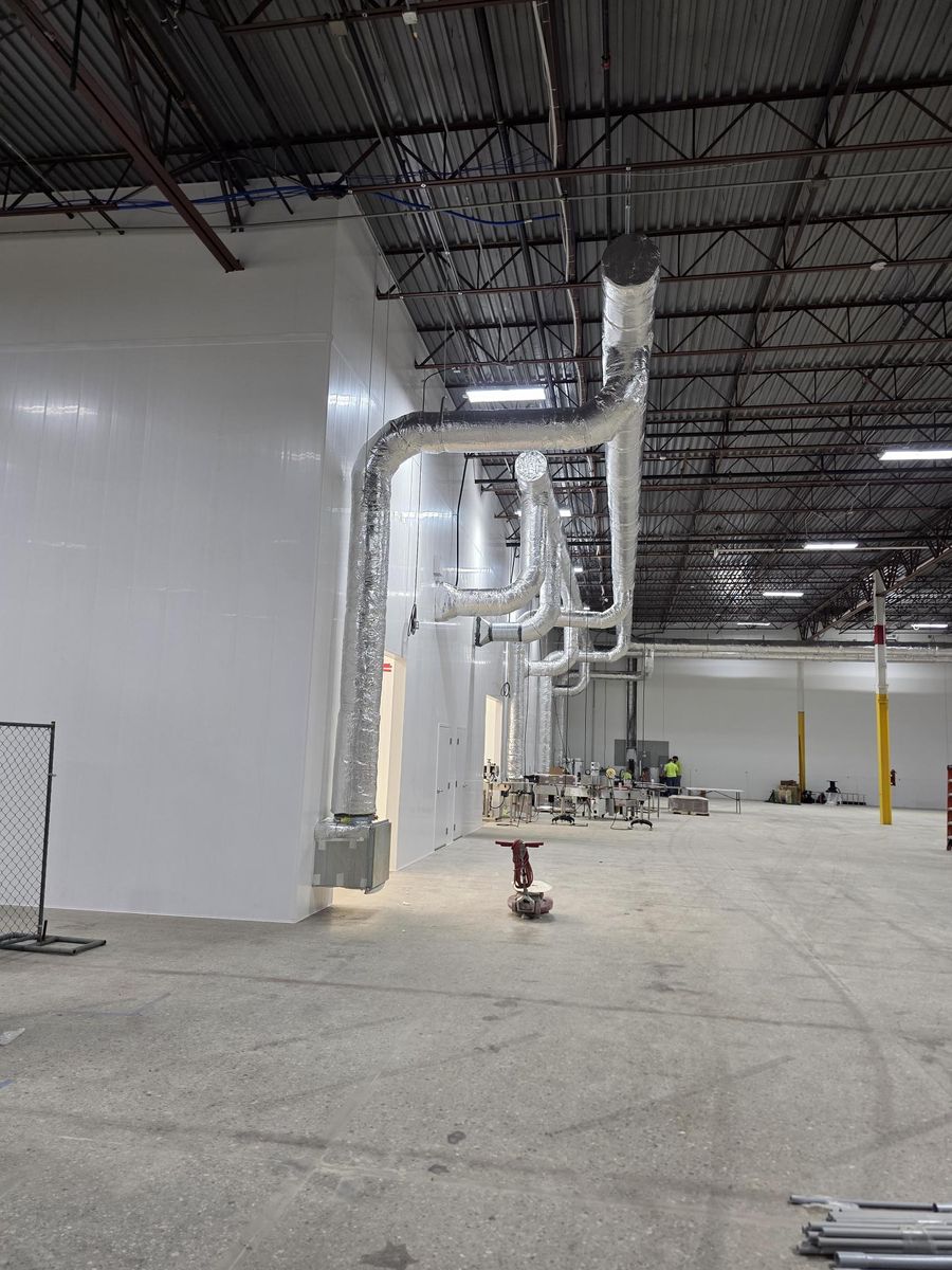 Food-grade warehouse interior with insulated metal panel walls and overhead ductwork