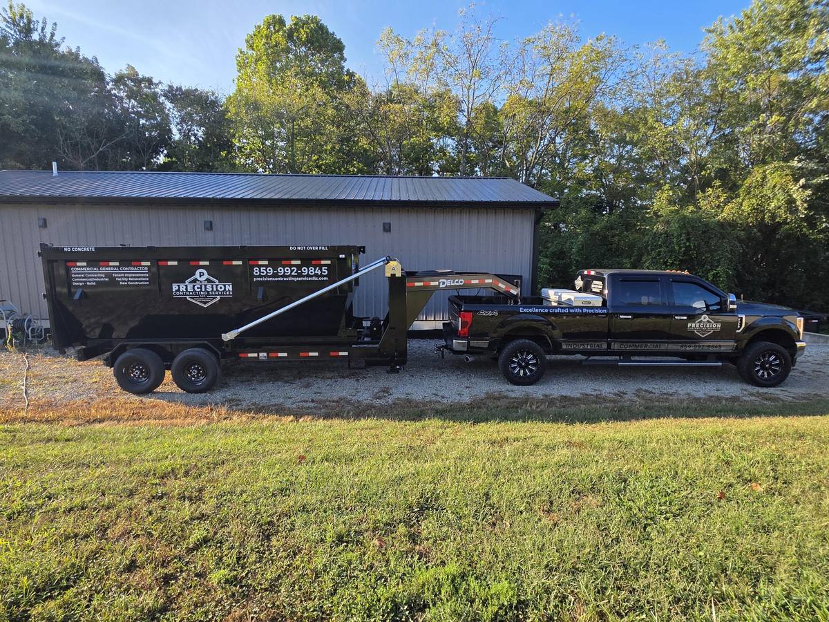 Precision Contracting Services roll-off dumpster and company truck